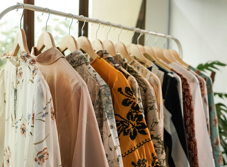 Curated boutique outfits on wooden hangers