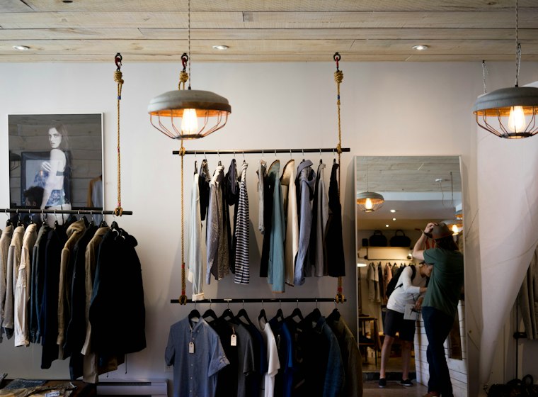 Boutique interior with clothing racks and mirror