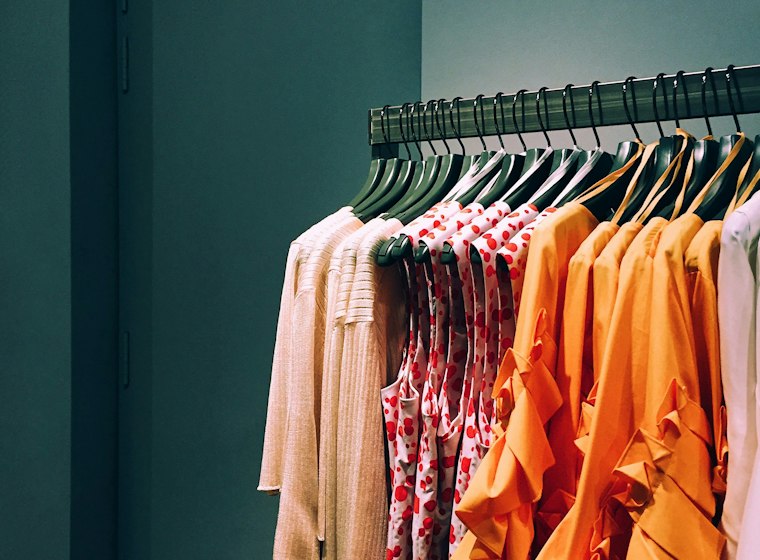 Assorted apparel hanging on a store rack